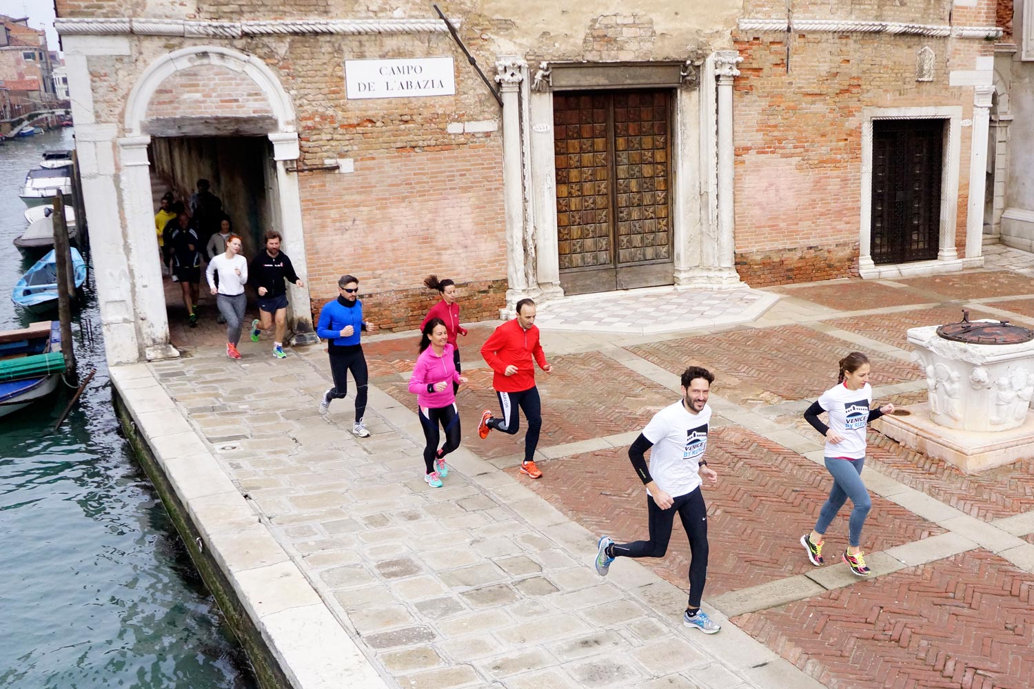 Runners in a campo of Venice