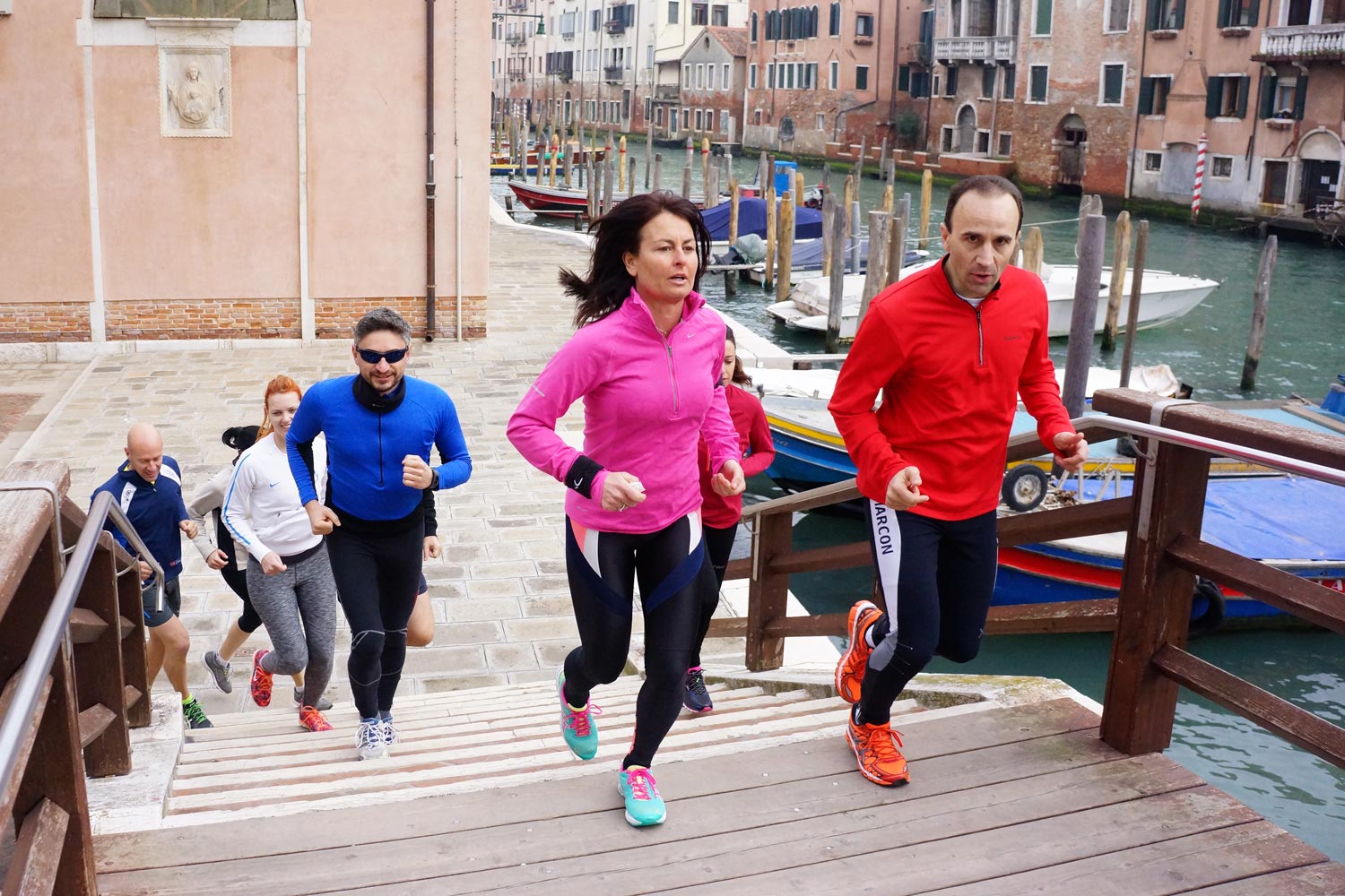 Runners in Venice crossing a bridge