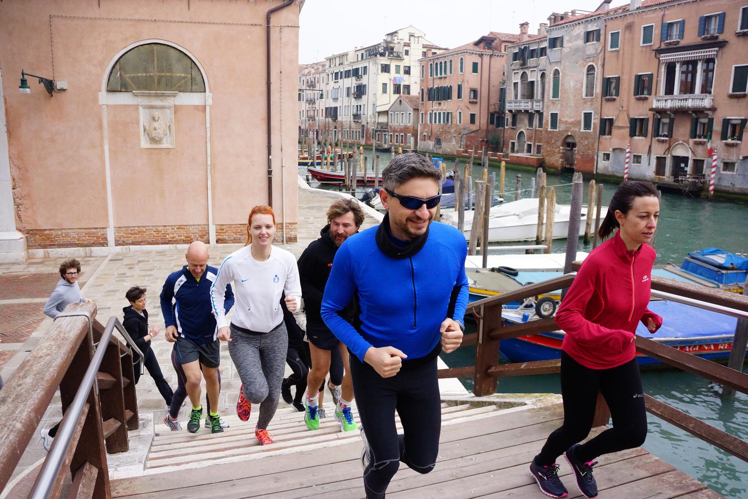 Runners in Venice crossing a bridge