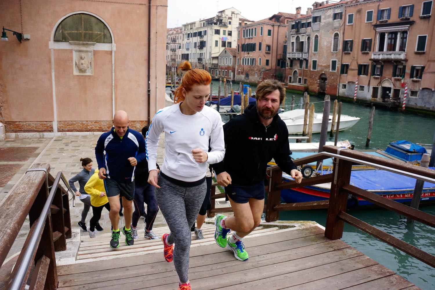 Runners in Venice crossing a bridge