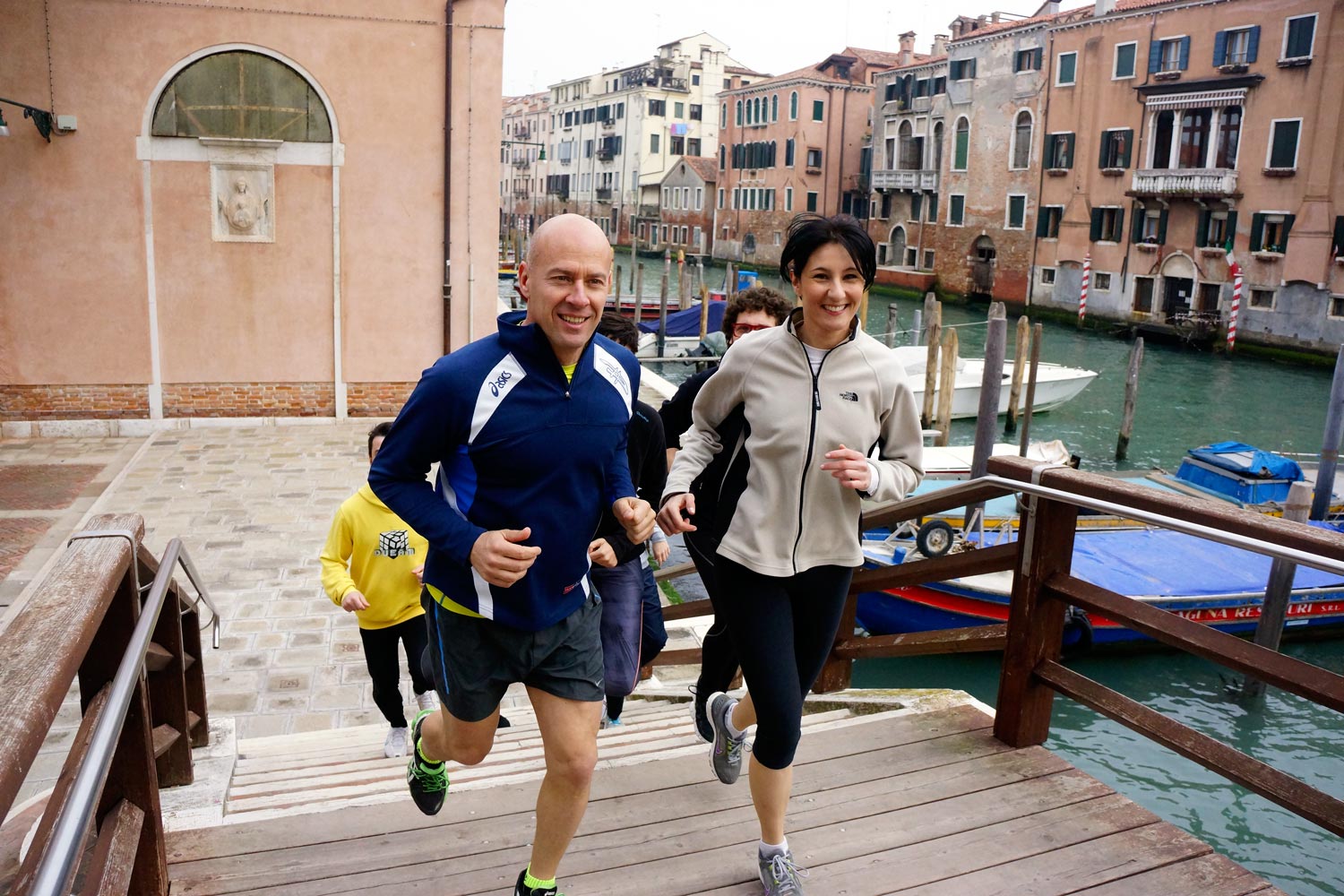 Runners in Venice crossing a bridge