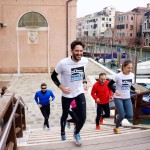 Runners in Venice crossing a bridge