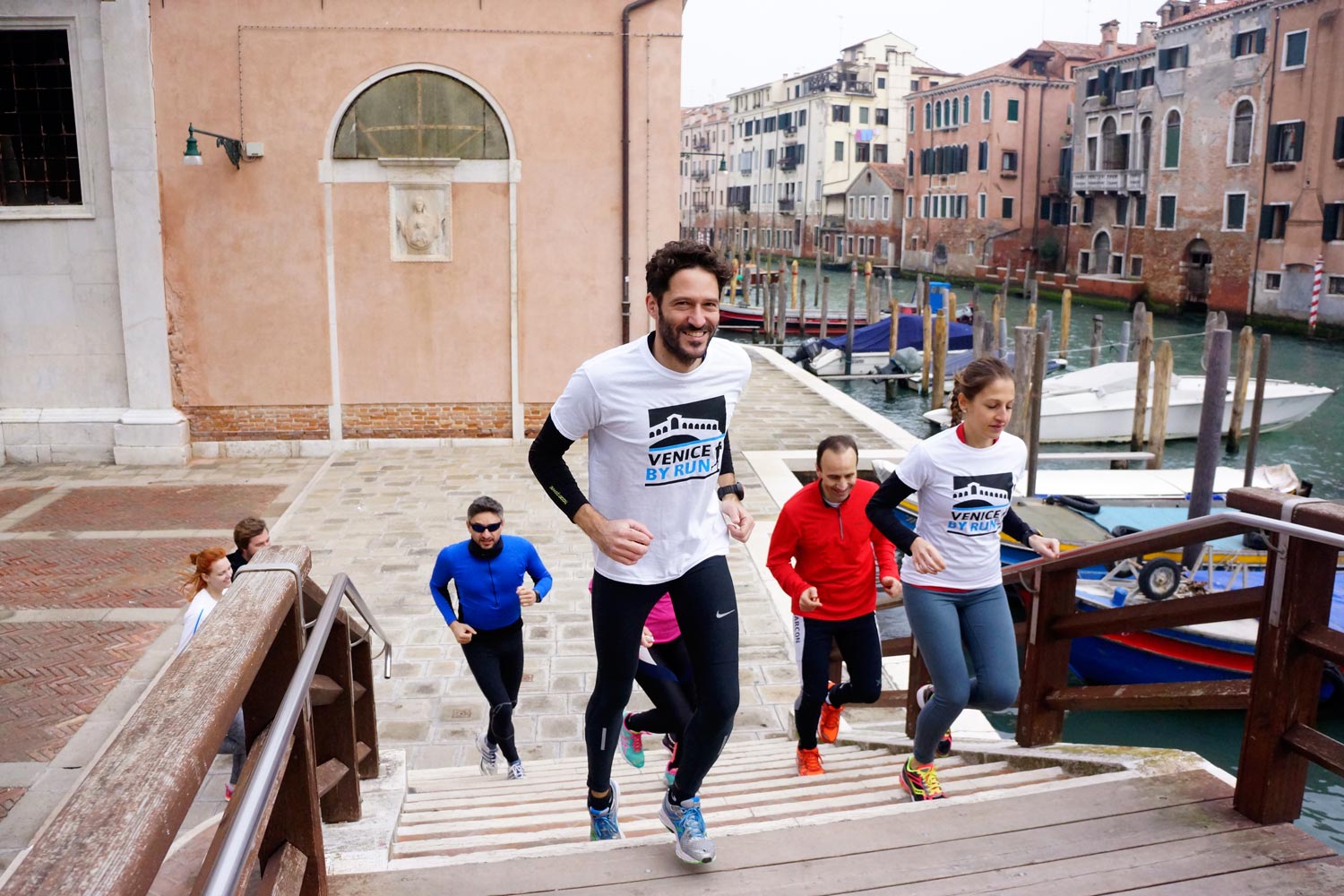 Runners in Venice crossing a bridge